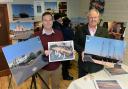 Saundersfoot Harbour chief executive Mike Davies and harbour commissioner Pip Parker are pictured with the visuals of the tall ship building, the completed decking and Ocean Square that can be seen at the exhibition. PICTURE: Gareth Davies Photography.