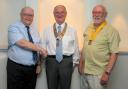 Rotary Club of Saundersfoot Immediate Past President Haydn Williams hands the chain of office to new president Neil Sefton, accompanied by new president elect Brian Jenkins.