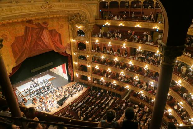 Western Telegraph: A grand theatre with people watching an orchestra. Credit: Canva