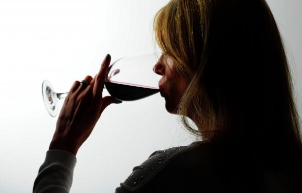 Western Telegraph: A woman drinking red wine. Credit: PA