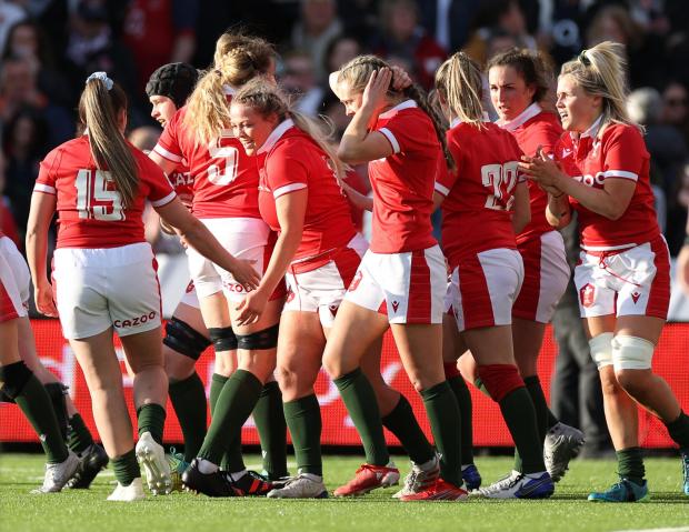 Western Telegraph: Kelsey Jones of Wales celebrates her score with team mates. Picture: Chris Fairweather/Huw Evans Agency