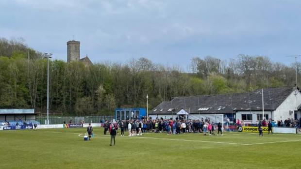 Western Telegraph: Fans on the pitch for the final day of the season, Haverfordwest losing 2-0 to Cardiff Met