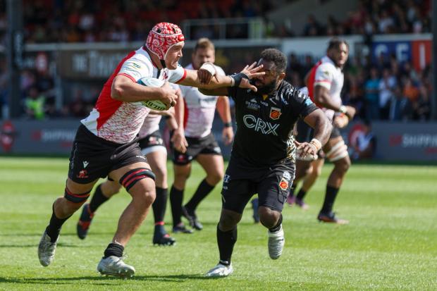Western Telegraph:  Ruan Venter of Emirates Lions hands off a Dragons player on the way to scoring a try. Picture: Gruffydd Thomas/Huw Evans Agency