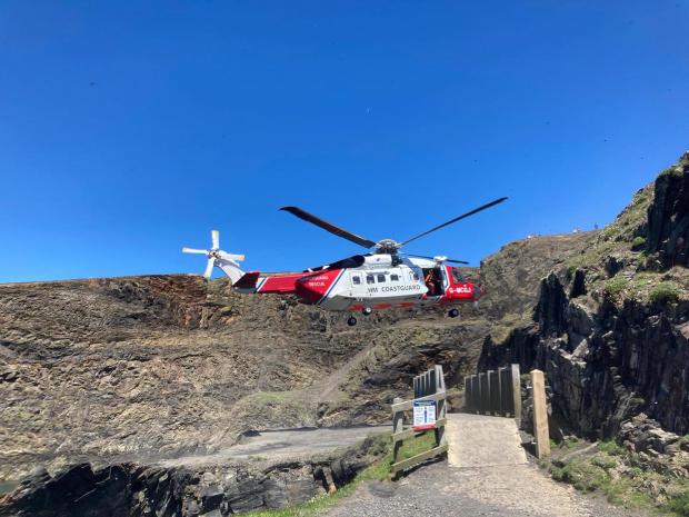 Western Telegraph: The coastguard helicopter flew the injured man to hospital in north Wales. Picture: HM Coastguard, Fishguard