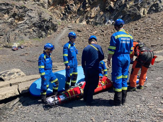 Western Telegraph: The injured man was rescued by paddleboard and carefully transferred to a stretcher. Picture: HM Coastguard Fishguard