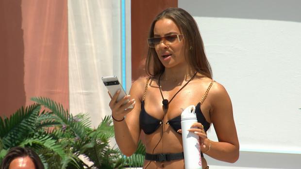 Western Telegraph: Danica gets a text as Love Island continues tonight at 9pm on ITV2 and ITV Hub. Episodes are available the following morning on BritBox. Credit: ITV