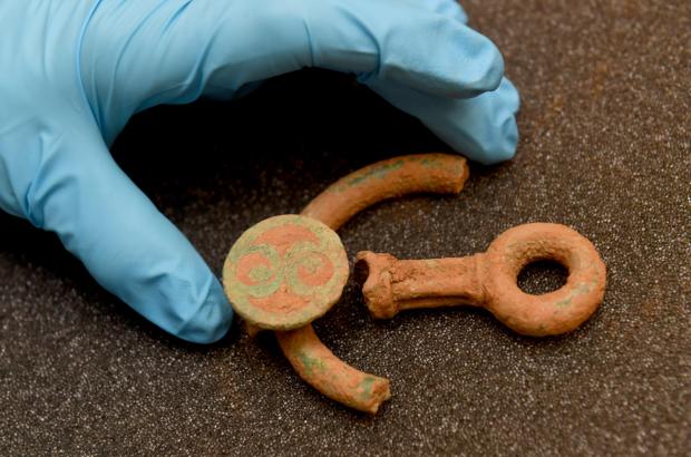 Western Telegraph: Placing the decorated bridle bit fragments. Picture: National Museum Wales