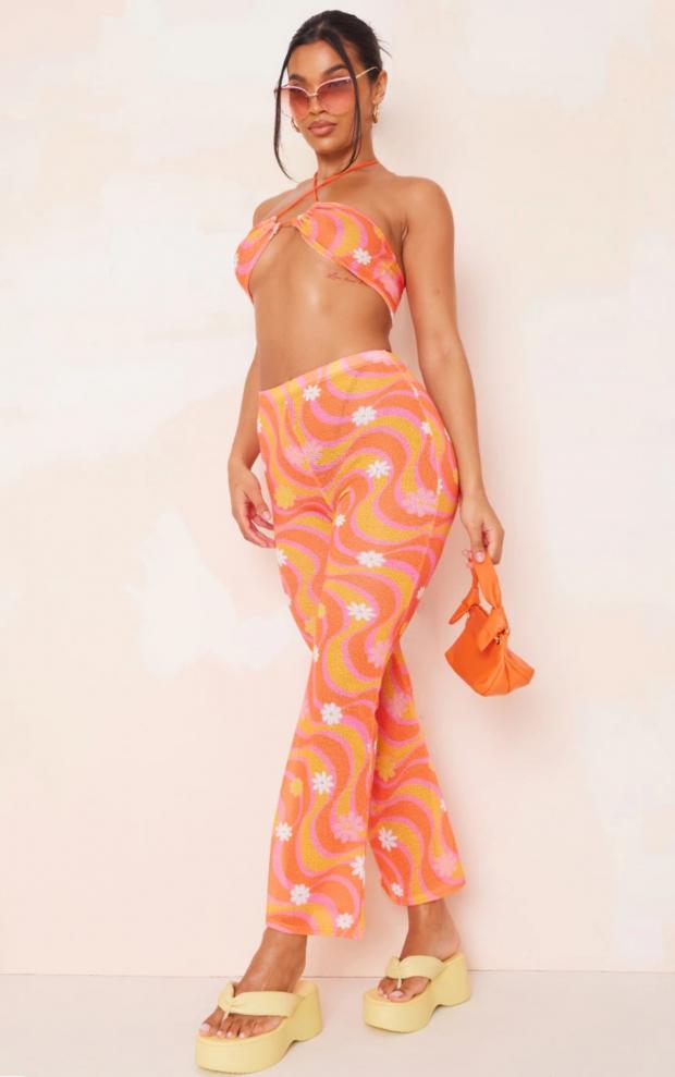 Western Telegraph: Orange Flower Swirl Print Knit Flare Trousers (PrettyLittleThing)