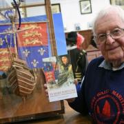 David James with his previous book Ye Mary Fortune and a model of the ship he constructed. PICTURE: Martin Cavaney