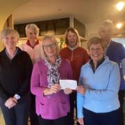 Outgoing lady captain, Susan Waterhouse, presents a cheque for £900 to Sylvia Hotchin, chairperson of Fishguard and Goodwick RNLI fundraisers, accompanied by incoming lady captain Kate Rotherford (far left) and other members of the golf committee