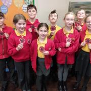 Pupils at Holy Name School Fishguard with their sew on school logos. Picture: Western Telegraph