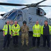 Pictured with a member of the Royal Navy crew are (from left) Airport Supervisor Tim Brickwood and Airport Assistants Terry Treiber Johnson, Bryn Etchells, and Phil Davies.
