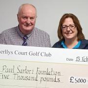 Derllys Court Golf Club Captain Teifryn Bowen is pictured presenting a cheque for £5,000 to Sandra Dade, charity manager at Paul Sartori Foundation. Picture: Paul Sartori