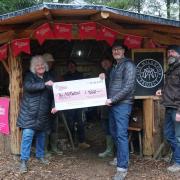 Pictured with the National Lottery cheque in the shelter of The Milkwood Project's new roundhouse are project secretary Lynne Crompton, director Lee Burton and treasurer Gideon Petersen.