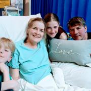 Julianna in hospital with husband Tim and children Emilia and William.