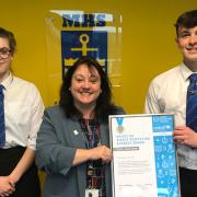 Milford Haven School headteacher Ceri-Anne Morris and pupils are pictured with the Unicef UK award.