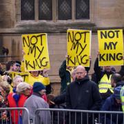 Protesters await the arrival of the King in York (PA)