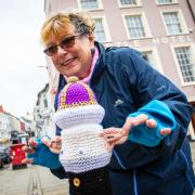 Yarn-bomber Lin Wheeler with one of  the Coronation creations in Haverfordwest.