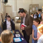 Stephen Crabb MP with pupils from Broad Haven School at their climate injustice exhibition in Broad Haven Chapel.
