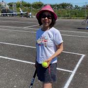 Club chairman Queenie Scale warms up for the reopening of the town' tennis court