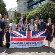 Military children from  Haverfordwest High VC School and Prendergast Community School with members of 14th Signal Regiment, 948 Squadron RAF Cadets, and Pembrokeshire council staff.