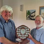 Tenby Camera Club chairman Dave Lewis presents Dave Bolton with the Photographer of the Year 2023 trophy.