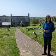 Trust secretary Alison Gibby has helped harness a £5,000 grant in the campaign  to save St Madoc of Ferns in the background