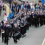 The crew of HMS Pembroke and local sea cadets parade through the town.