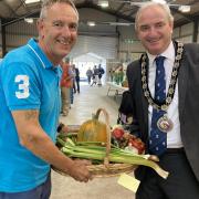 Pembrokeshire County Council chairman, Tom Tudor, congratulates Richard Davies on his top score in the Pembrokeshire County Show horticultural section for the 23rd year in a row.