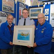 Air Commodore Adrian Williams receiving the Sunderland T9044 print from Heritage Trust Chairman Graham Clarkson (right) and Patron John Evans.