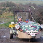 Buzz Knapp-Fisher, artist and environmental activist and the three -wheeler he made (1999).