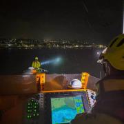 Angle RNLI Lifeboat searches in the dark for the woman in the water.