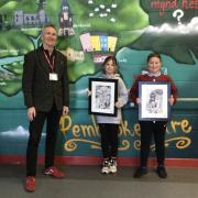 Margaret Jones’ son Mark with pupils at Prendergast CP School and some of her artworks gifted to the school.
