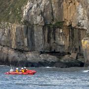 Tenby RNLI's crew were called out to help after a climber fell 15 feet