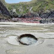 The public is being urged to proceed with caution as the tides have exposed the WW2 mines which may be sharp.