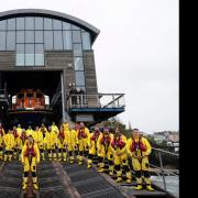 Tenby RNLI coxswain Phil John poses proudly with his crew.