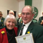 Pembroke and District Male Voice Choir Conductor Christine Lloyd presents the 30-Year Membership Certificate to Charles Hare.