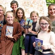 Saundersfoot CP School's successful BookSlam team of Evie, Anya, Ada, Nel and Amelia are pictured with contest judges, Meinir Wyn Edwards and Eloise Williams..