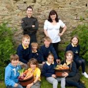 Grove chef James Hogarth Jones and Assistant Manager Rose Thompson get green-fingered in the garden with pupils from Ysgol Bro Dewi in St. David’s