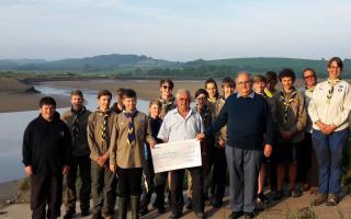 Preseli Pioneers Explorer Scout group members are pictured receiving the cheque from George Bancroft and Freemason Patrick of the Freemasons of West Wales.