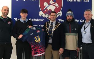 Laugharne's Portreeve, Anthony James,  presents the shirts to Ysgol Dyffryn Taf.
